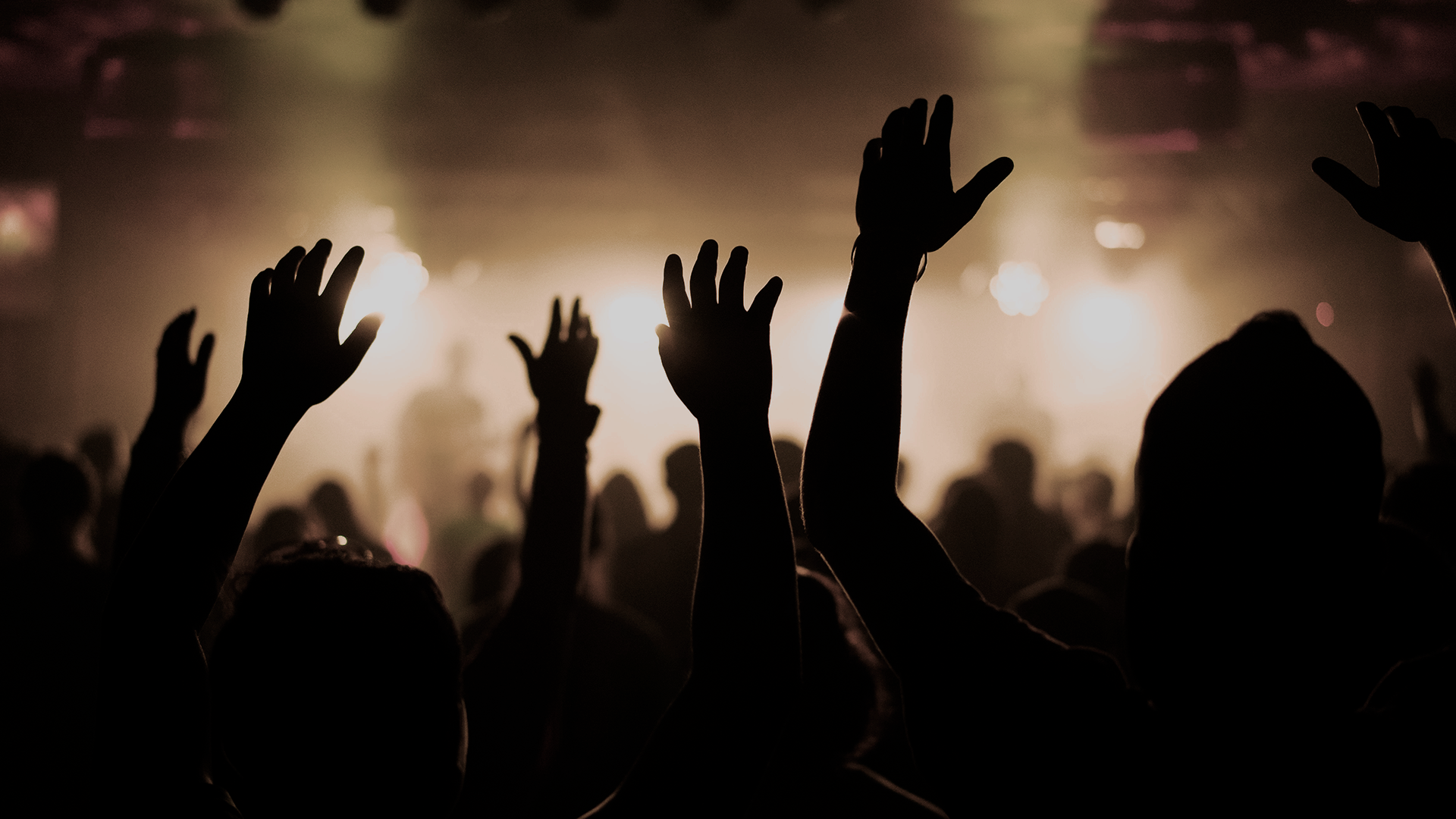 Black and white photo of teens rehearsing a dance routine on a stage.