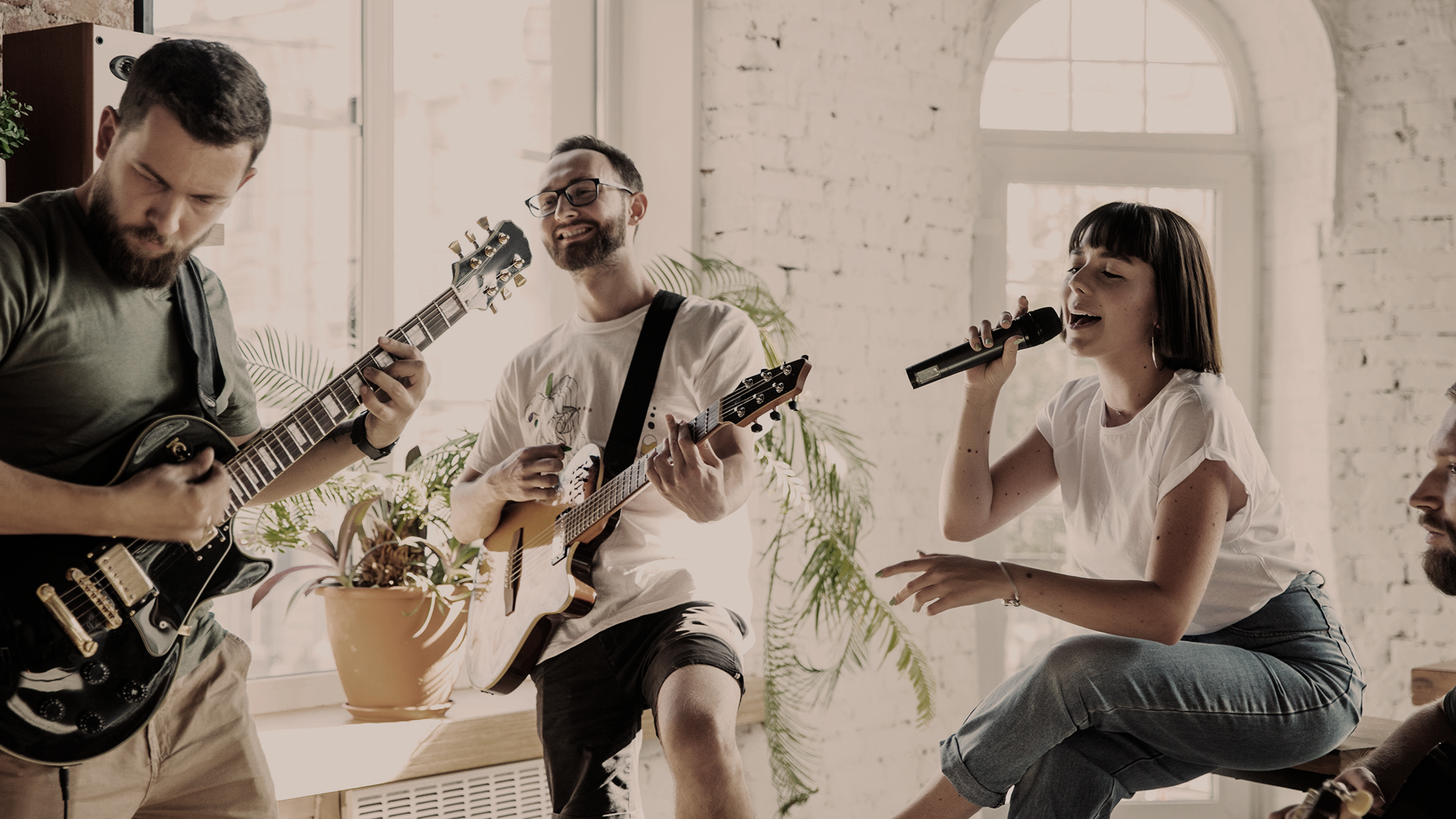 Photo of a silhouette of 2 dancers posing in front of a red curtain.