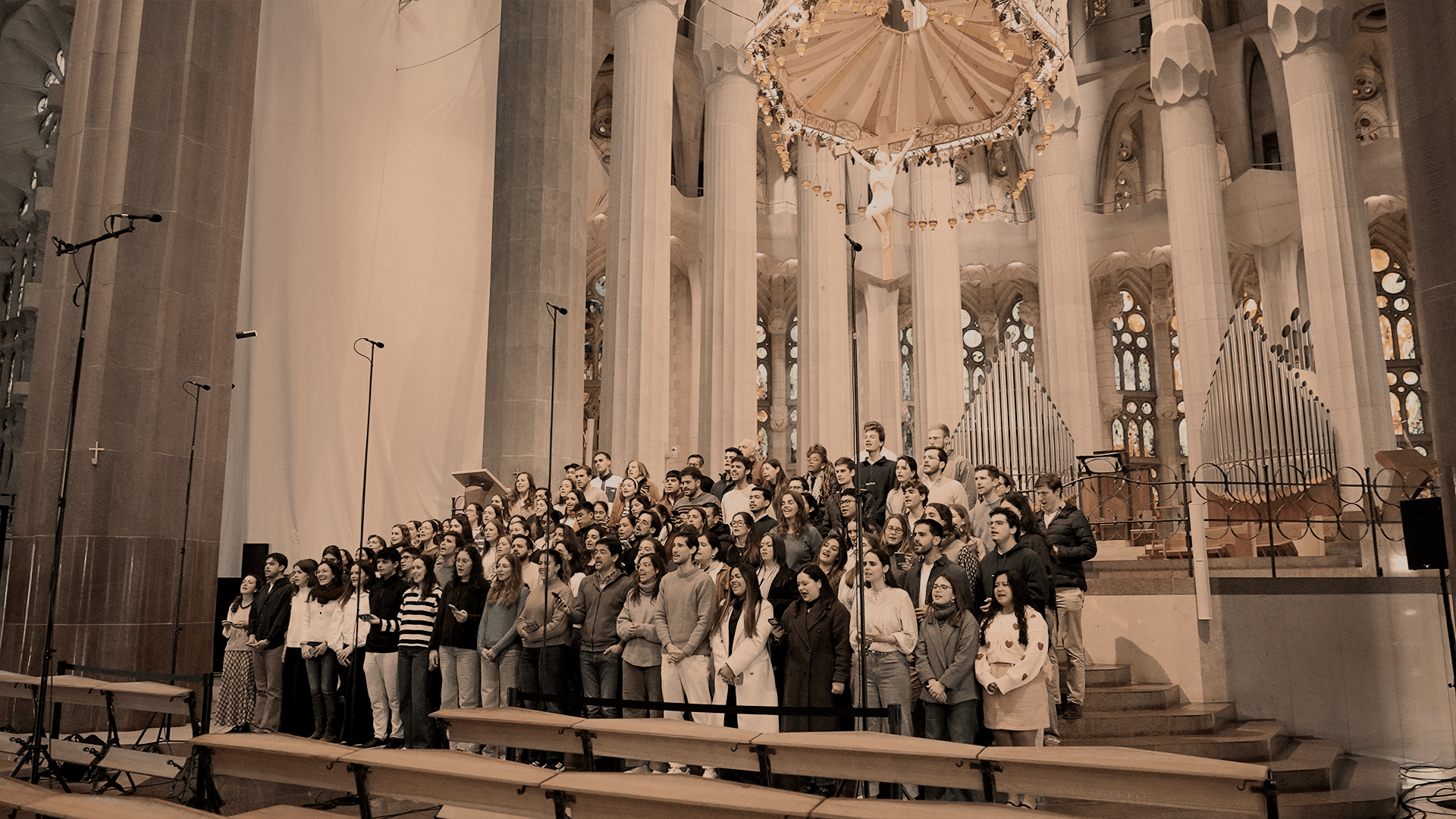 Photo of a silhouette of 2 dancers posing in front of a red curtain.